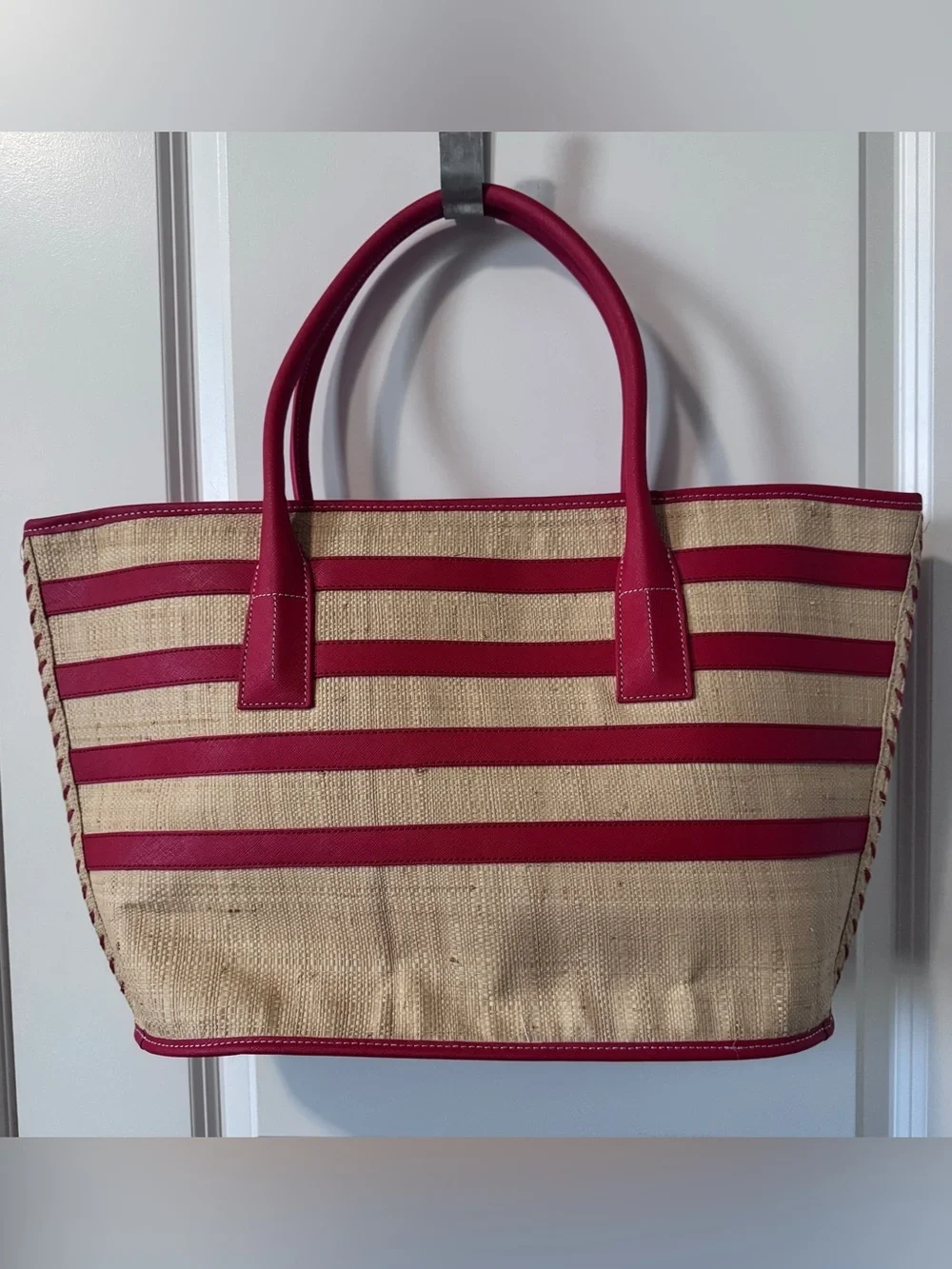 Tory Burch straw tote features vibrant red leather stripes